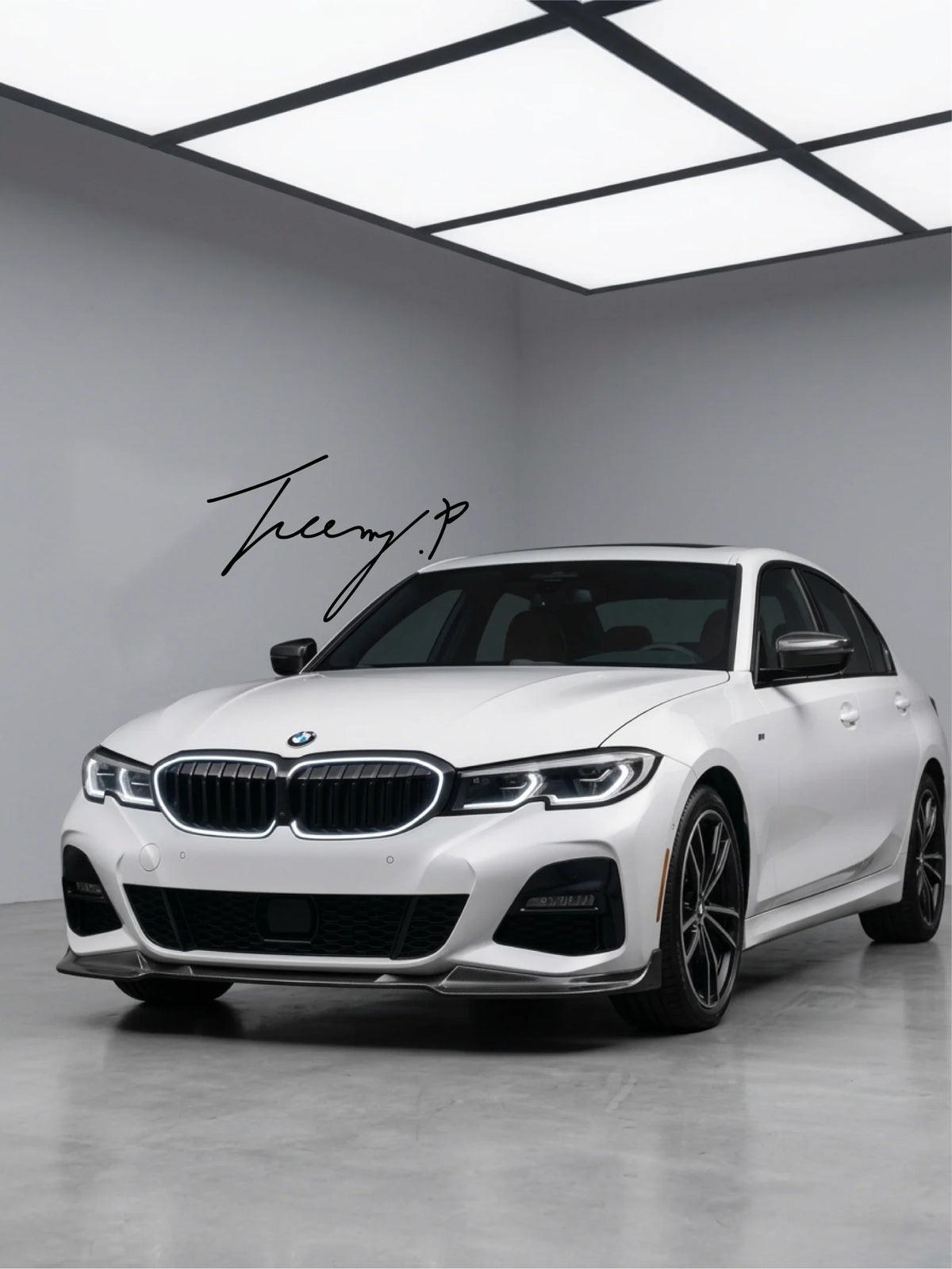 Front angle view of gloss black double-slat LED light bar kidney grille installed on a 2019 to 2022 BMW 3 Series G20.