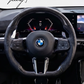 Carbon fiber heated performance steering wheel installed on a 2018-2024 BMW X1/X2 (F39), 5 Series (G30/G31), X3 (G01), X5 (G05), X6 (G06), X7 (G07), or M3 (G80)