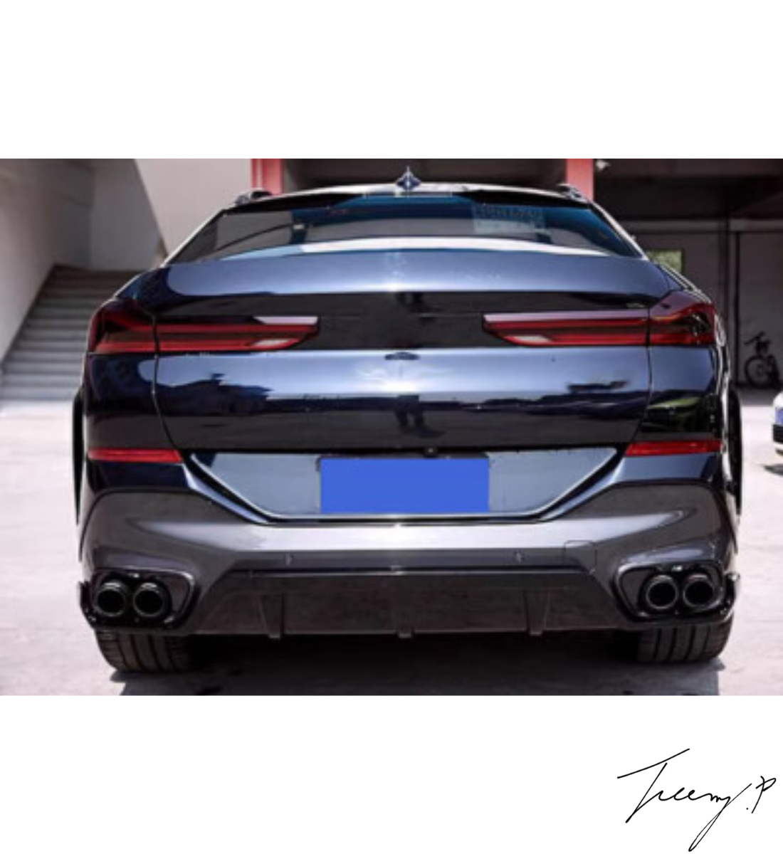Gloss black rear bumper diffuser, lip splitters, and body kit installed on a 2019-2023 BMW X6 G06