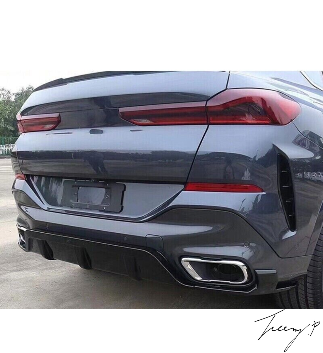Gloss black rear bumper diffuser, lip splitters, and body kit installed on a 2019-2023 BMW X6 G06