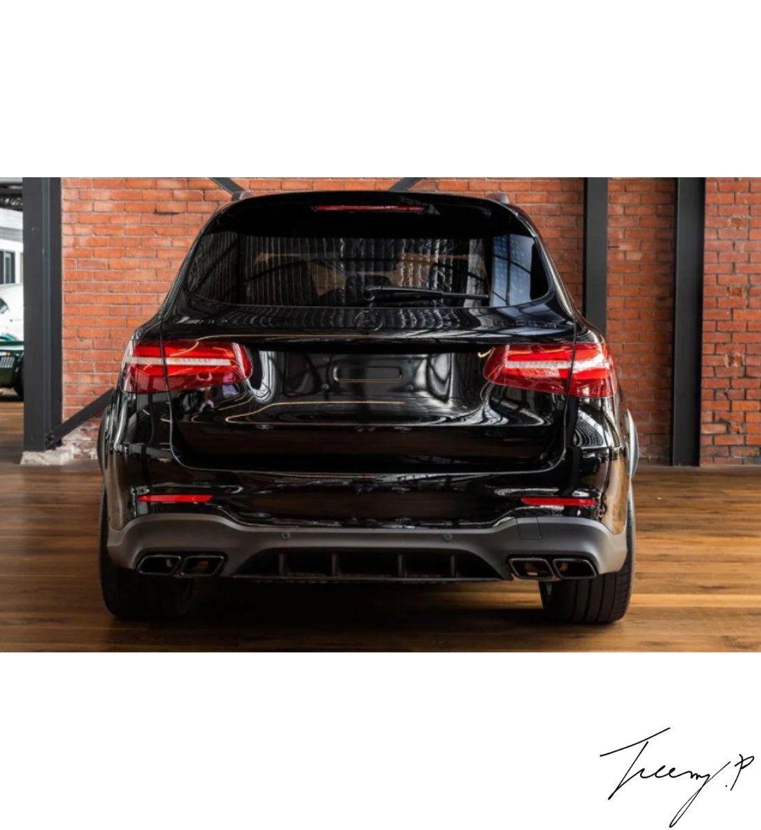 Gloss black GLC63 AMG style rear diffuser with quad exhaust tailpipes installed on a 2016-2019 Mercedes-Benz GLC-Class X253.
