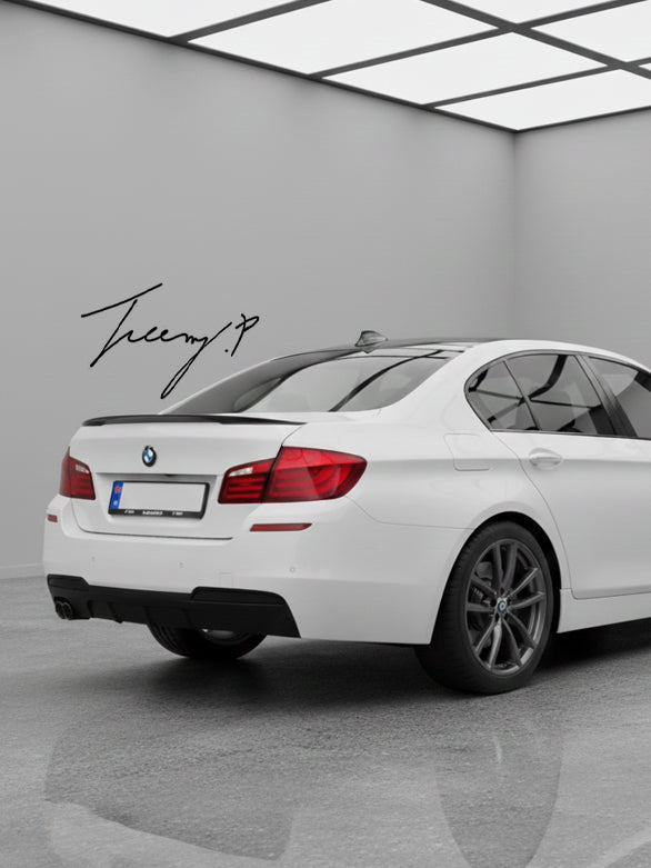 Gloss black twin-exit rear valance diffuser installed on a 2010-2017 BMW 5 Series (F10 / F11) M Sport