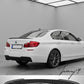Gloss black twin-exit rear valance diffuser installed on a 2010-2017 BMW 5 Series (F10 / F11) M Sport