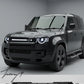 Gloss black front grille with integrated LED light installed on a 2020-2026 Land Rover Defender (L663)
