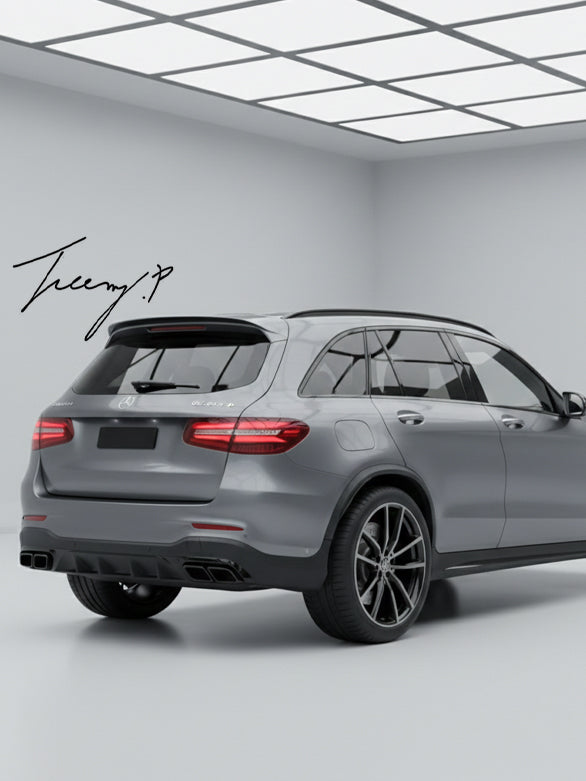 Gloss black GLC63 AMG style rear diffuser with quad exhaust tailpipes installed on a 2016-2019 Mercedes-Benz GLC-Class X253.
