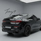 Gloss black rear bumper diffuser, lip splitters, and body kit installed on a 2019-2023 BMW X6 G06