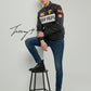 Black unisex leather-look Ferrari racing jacket with embroidered F1-style branding and hood.