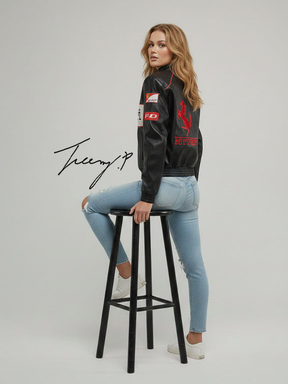 Black unisex leather-look Ferrari racing jacket with embroidered F1-style branding and hood.