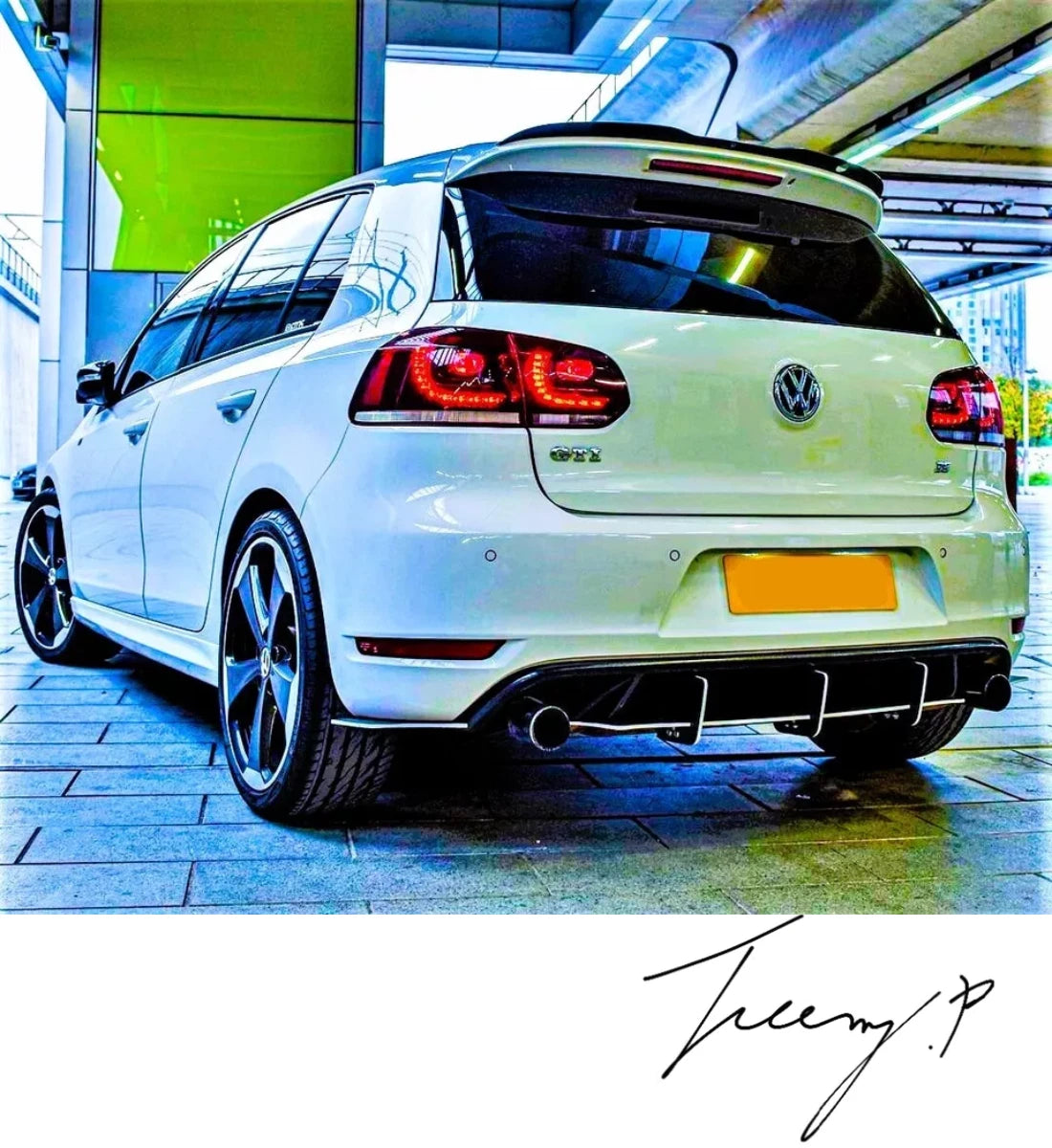Gloss black rear blade fin diffuser and side splitters body kit installed on a 2008-2013 Volkswagen Golf GTI MK6